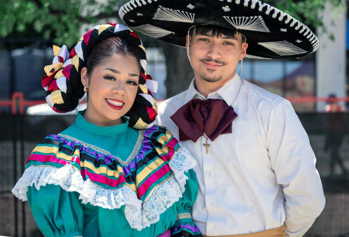 Two people pose at the Tucson International Mariachi Conference in Mariachi Attire