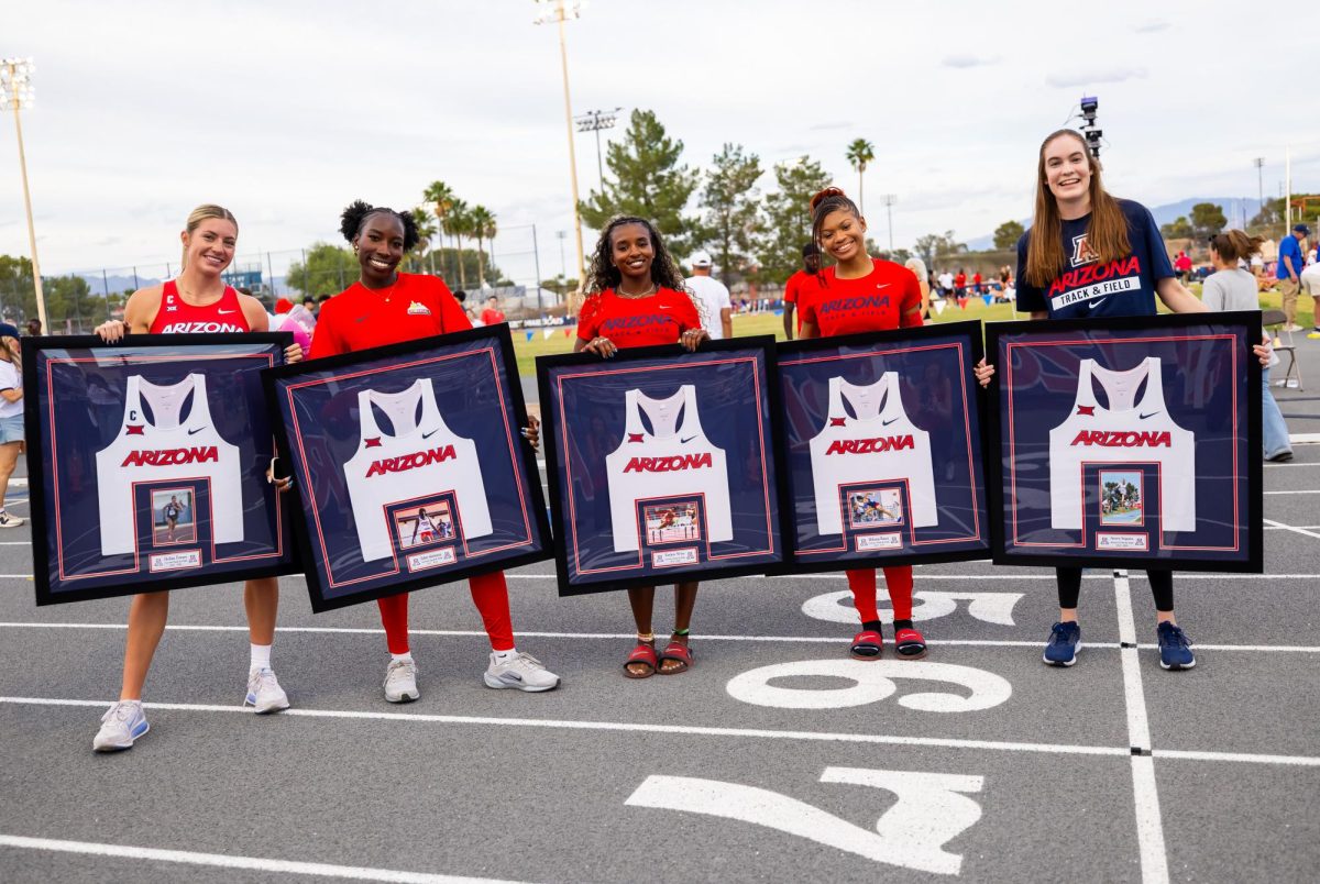 Seniors (from left to right) Emma Gates, Esther Akinlosotu, Taylen Wise, McKenna Watson  and Avery Segura hold up framed jerseys at Roy P. Drauchman Stadium on Saturday, May 2, 2026. (Courtesy of UA Athletics)
