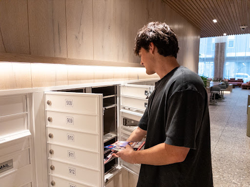 Noah Glenn distributes mail to all residents of the Hub Tucson First apartment building on Park Avenue on March 4, 2026.